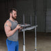 body solid powerline vertical leg press pvlp156x man loading olympic plate