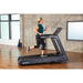 Woman running on a SportsArt treadmill in a bright room