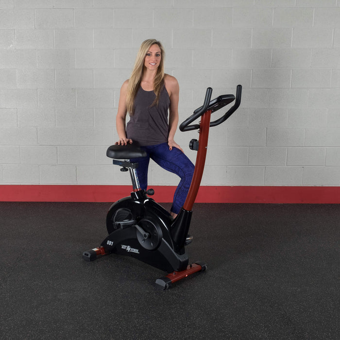 woman behind body solid bfub1 upright bike